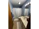 A clean bathroom that features a toilet, shower behind a curtain, and neutral toned walls at 18316 Keene Rd, Altoona, FL 32702