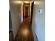 Hallway with hardwood floors leading to the entrance of various rooms at 18316 Keene Rd, Altoona, FL 32702