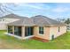 An aerial view of the back exterior of a tan house with a screened in porch at 1841 Dunn Cove Dr, Apopka, FL 32703