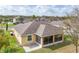 Backyard aerial showcasing tan home, screen enclosed porch with view of the neighborhood at 1841 Dunn Cove Dr, Apopka, FL 32703