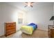 The bedroom has carpet flooring, a ceiling fan, and a window at 1841 Dunn Cove Dr, Apopka, FL 32703