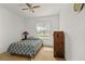 This bedroom features carpet, natural light, and a ceiling fan at 1841 Dunn Cove Dr, Apopka, FL 32703