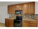 The kitchen features oak cabinetry, a black microwave, and a tiled backsplash at 1841 Dunn Cove Dr, Apopka, FL 32703