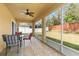 A screened patio with a ceiling fan and view of the fenced backyard at 1841 Dunn Cove Dr, Apopka, FL 32703