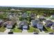 Aerial view showcasing the neighborhood with lush greenery and well-maintained homes, including the subject property at 1917 Emily Blvd, Winter Haven, FL 33884