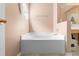 Relax in this tub situated in a peach-toned bathroom, perfect for unwinding at 1917 Emily Blvd, Winter Haven, FL 33884