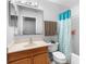 Bathroom featuring a wood vanity and sink and a blue shower curtain at 1917 Emily Blvd, Winter Haven, FL 33884