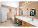 Bathroom featuring a bathtub, vanity with sink, large mirror, and tile flooring at 1917 Emily Blvd, Winter Haven, FL 33884