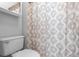 The white toilet offers a clean look, complemented by a patterned shower curtain at 1917 Emily Blvd, Winter Haven, FL 33884