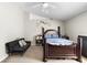 Neutral bedroom featuring a ceiling fan, vaulted ceiling and elegant dark wood furniture at 1917 Emily Blvd, Winter Haven, FL 33884