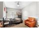 Neutral bedroom featuring a ceiling fan, natural light, and a brown leather armchair at 1917 Emily Blvd, Winter Haven, FL 33884