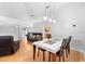 Open-concept dining area features modern pendant lighting and wood floors, perfect for entertaining guests at 1917 Emily Blvd, Winter Haven, FL 33884