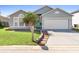 Charming single-story home with well-manicured lawn, palm tree, and light blue front door at 1917 Emily Blvd, Winter Haven, FL 33884