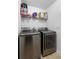 Modern laundry room with front-load washer and dryer, plus shelving above at 1917 Emily Blvd, Winter Haven, FL 33884