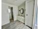 Cozy bathroom featuring new floors, modern sink with storage, and an updated shower at 206 Aspen Cir, Leesburg, FL 34748