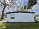 Clean white exterior of the home with well-maintained landscaping at 206 Aspen Cir, Leesburg, FL 34748