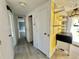 Hallway featuring access to a bedroom with neutral paint and light floors at 206 Aspen Cir, Leesburg, FL 34748