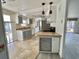 Well-lit kitchen with light gray cabinets, tile backsplash, stainless steel appliances, and easy access to the porch at 206 Aspen Cir, Leesburg, FL 34748