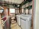 Practical laundry room with modern washer and dryer units and ample storage at 206 Aspen Cir, Leesburg, FL 34748