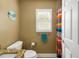 Well-lit bathroom featuring a granite vanity top, wood cabinets, shuttered window, and bathtub shower combo at 2165 Smoaks St, The Villages, FL 32162