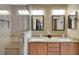 Bathroom showcasing walk-in shower and double vanity with granite countertops at 2165 Smoaks St, The Villages, FL 32162