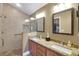 Bathroom features a walk-in shower and double vanity with granite countertops at 2165 Smoaks St, The Villages, FL 32162