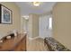 Inviting foyer with light wood floors, neutral walls, decorative bench, and lots of natural light at 2165 Smoaks St, The Villages, FL 32162