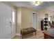 Bright foyer features hardwood floors, front door with glass, and interior bench with floral pattern at 2165 Smoaks St, The Villages, FL 32162