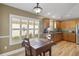 Charming kitchen featuring wood cabinets, modern appliances, and a cozy breakfast nook with natural light at 2165 Smoaks St, The Villages, FL 32162