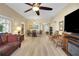 Spacious living room with fireplace, ceiling fan and sliding doors to the outside at 2165 Smoaks St, The Villages, FL 32162