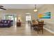 Spacious living area featuring hardwood floors and large windows for natural light at 2165 Smoaks St, The Villages, FL 32162