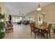 Bright living room with hardwood floors, fan, vaulted ceiling, and lots of natural light at 2165 Smoaks St, The Villages, FL 32162