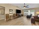 Inviting living room with hardwood floors, vaulted ceiling, fan, and natural light at 2165 Smoaks St, The Villages, FL 32162