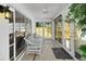 Bright sunroom featuring tile flooring, ceiling fan, and sliding doors leading to the outdoor patio at 2165 Smoaks St, The Villages, FL 32162