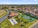 Aerial view of the community's recreational facilities including a tennis court, playground, and sand volleyball court at 231 Brunello Dr, Davenport, FL 33897