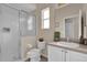 Bathroom featuring a toilet, single sink vanity, and a glass enclosed walk-in shower at 231 Brunello Dr, Davenport, FL 33897