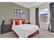 Bedroom featuring a statement red bed frame, modern décor, and ample natural light at 231 Brunello Dr, Davenport, FL 33897