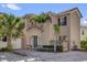 Charming two-story home with a tile roof, front entry columns, and beautiful brick-paved driveway at 231 Brunello Dr, Davenport, FL 33897