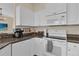 Well-equipped kitchen featuring white appliances and cabinetry, and granite countertops at 231 Brunello Dr, Davenport, FL 33897