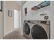 Well-equipped laundry room featuring a modern washer and dryer and convenient storage shelves at 231 Brunello Dr, Davenport, FL 33897