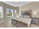 Sun-drenched main bedroom boasts a king bed, stylish accents, and serene outdoor views from the window at 231 Brunello Dr, Davenport, FL 33897