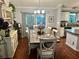 Elegant dining room featuring a hardwood floors, stylish chandelier, and sliding glass doors that let in natural light at 2427 Tamarind Grove Run, The Villages, FL 32162