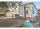 The backyard features light yellow siding, stone accents, and an air conditioning unit at 2557 Karen Dr, Mount Dora, FL 32757