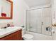 A well-maintained bathroom features a vanity sink and a shower with sliding doors at 2557 Karen Dr, Mount Dora, FL 32757