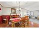 Dining area featuring a wood table and chairs set for four with views into the living room at 2557 Karen Dr, Mount Dora, FL 32757