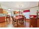 Dining area with wood table set for four, and views into an open kitchen and adjacent living spaces at 2557 Karen Dr, Mount Dora, FL 32757