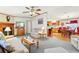 Open-concept living room flows into kitchen with wood cabinets and modern appliances at 2557 Karen Dr, Mount Dora, FL 32757