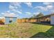 Wide view of backyard with shed, playset, covered patio, and grassy area at 2803 Joleen Dr, Eustis, FL 32726