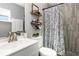 Stylish bathroom featuring tiled walls, modern fixtures, and decorative shelving at 2803 Joleen Dr, Eustis, FL 32726