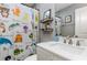 Bright bathroom with updated vanity and cabinet, themed shower curtain and decor at 2803 Joleen Dr, Eustis, FL 32726